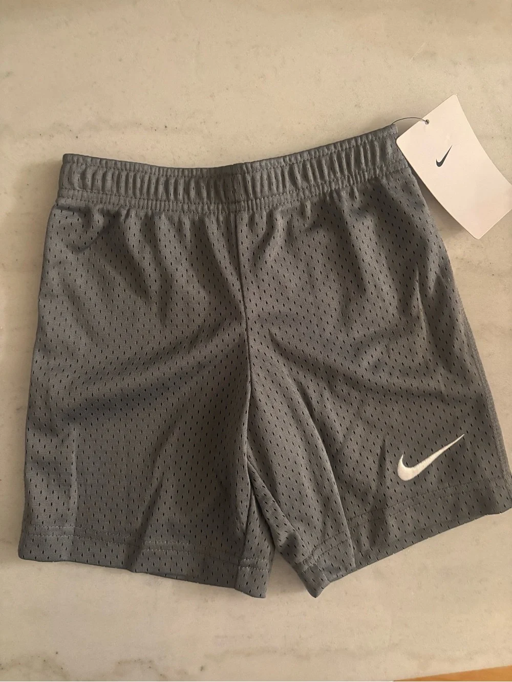 Nike Gray Perforated Kids Athletic Shorts with White Swoosh